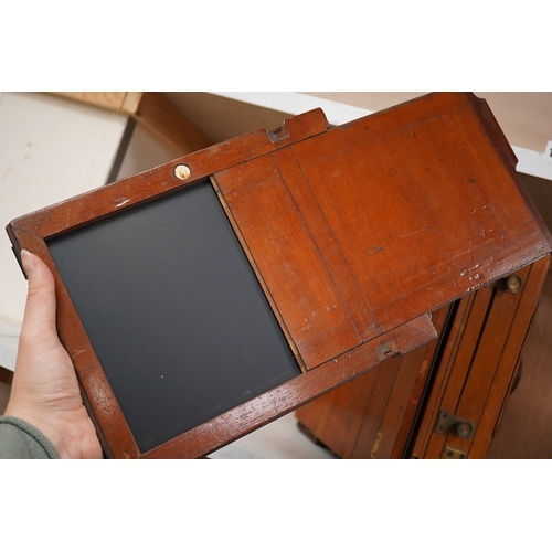 1256 - An early 20th century brass mounted mahogany full plate camera, together with a glass negative holde... 