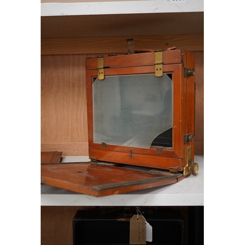 1256 - An early 20th century brass mounted mahogany full plate camera, together with a glass negative holde... 