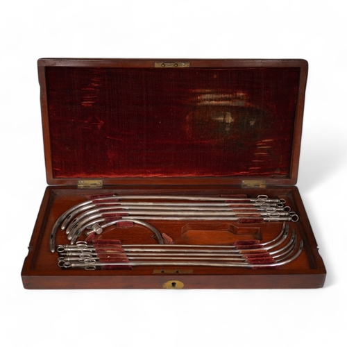 1257 - A mid 19th century mahogany cased medical set of catheter surgical instruments, inset plate to the l... 