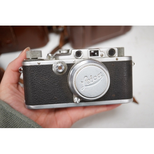 1271 - A Leica Model II camera in its original leather case, No. 204618, together with four additional came... 