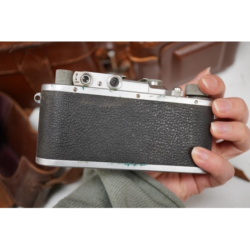 1271 - A Leica Model II camera in its original leather case, No. 204618, together with four additional came... 