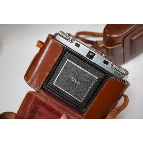 1271 - A Leica Model II camera in its original leather case, No. 204618, together with four additional came... 