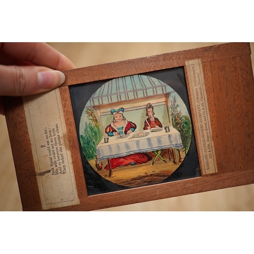 1273 - A mahogany and brass magic lantern in pine box, and a quantity of magic lantern slides by Primus, et... 