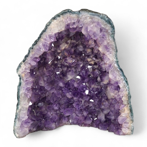 1280 - An amethyst geode specimen, 21.5cm high, 20.5cm wide at the base. Condition - fair to good.