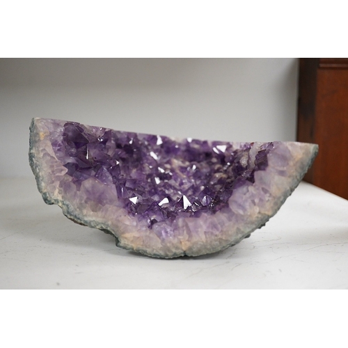 1280 - An amethyst geode specimen, 21.5cm high, 20.5cm wide at the base. Condition - fair to good.