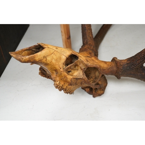 1283 - Two sets of deer antlers, one including the skull, the other with part of the skull, largest approxi... 