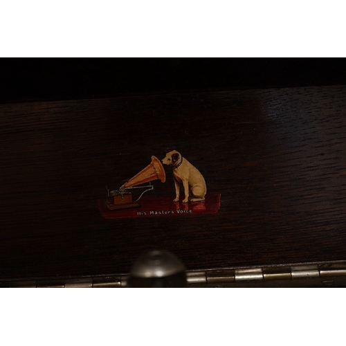 1285 - Two gramophone players; an oak cased HMV tabletop gramophone on a similar style mahogany gramophone ... 