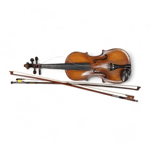 1288 - A late 19th century German violin, body 35cm long, and two bows. Condition - poor to fair.