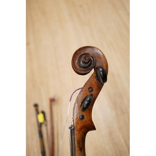 1288 - A late 19th century German violin, body 35cm long, and two bows. Condition - poor to fair.