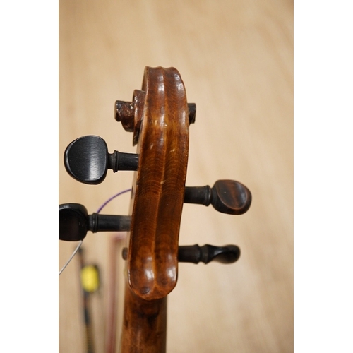 1288 - A late 19th century German violin, body 35cm long, and two bows. Condition - poor to fair.