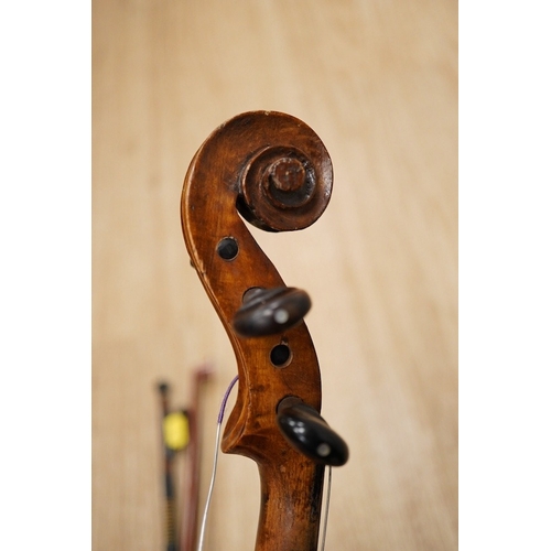 1288 - A late 19th century German violin, body 35cm long, and two bows. Condition - poor to fair.