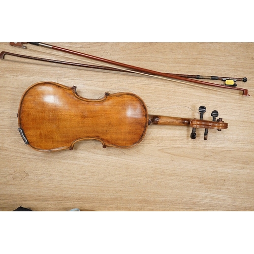 1288 - A late 19th century German violin, body 35cm long, and two bows. Condition - poor to fair.