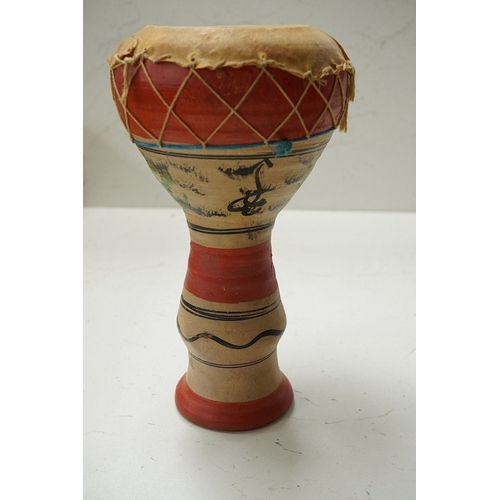 1293 - Five African drums; a Djembe, 60cm high, together with four small North African pottery double drums... 