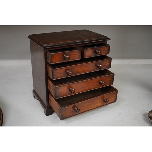 1330 - A 19th century miniature mahogany chest of five drawers, 28cm high. Condition - fair to good