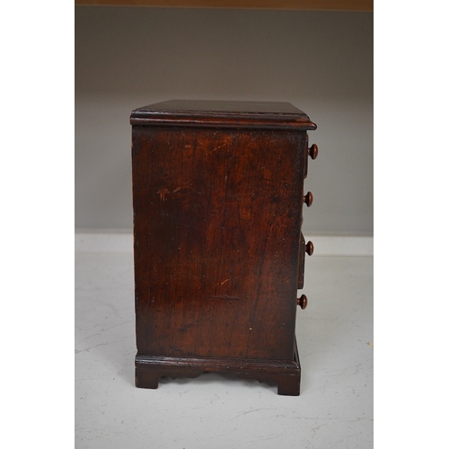 1330 - A 19th century miniature mahogany chest of five drawers, 28cm high. Condition - fair to good