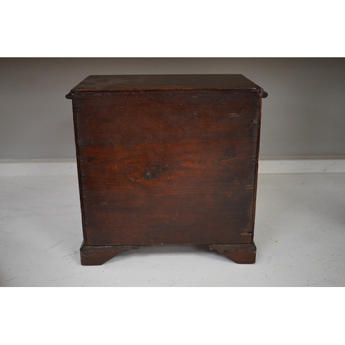 1330 - A 19th century miniature mahogany chest of five drawers, 28cm high. Condition - fair to good