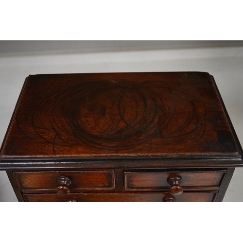 1330 - A 19th century miniature mahogany chest of five drawers, 28cm high. Condition - fair to good