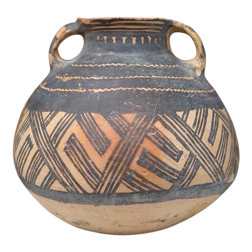 1336 - A Chinese neolithic pottery two handled jar - 14cm tall. Condition - fair to goodProvenance: the ven... 