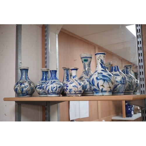 1343 - A large collection of Persian, predominantly blue and white, guglets, 18th century, largest 21.5cm. ... 