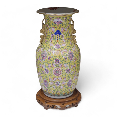 1359 - A late 19th century Chinese yellow ground porcelain vase, with gilt chilong handle, decorated with f... 