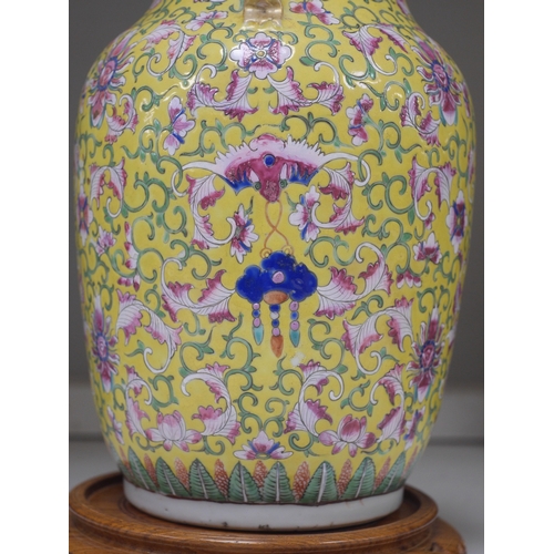 1359 - A late 19th century Chinese yellow ground porcelain vase, with gilt chilong handle, decorated with f... 