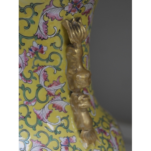 1359 - A late 19th century Chinese yellow ground porcelain vase, with gilt chilong handle, decorated with f... 