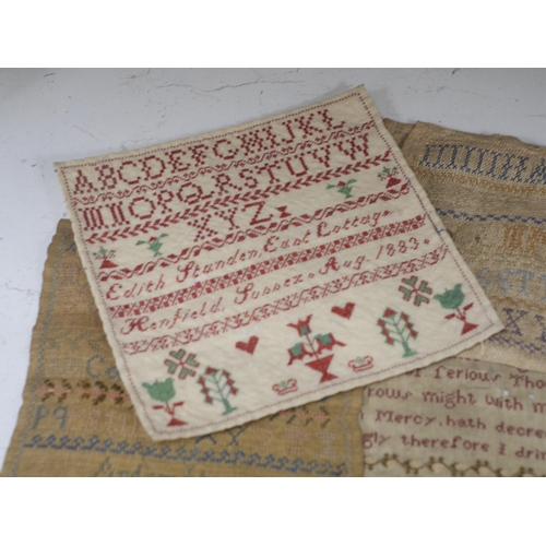 1362 - A collection of four 19th century cross stitch alphabet samplers and a larger earlier sampler embroi... 