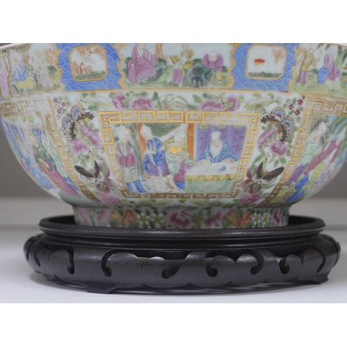 1363 - A 19th century Chinese famille rose bowl, on carved hardwood stand, 32cm diameter. Condition - chipp... 