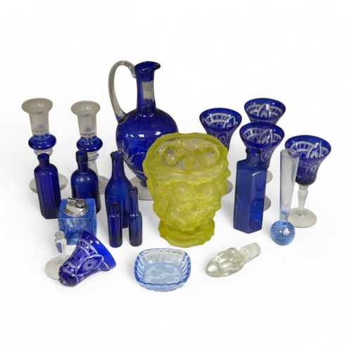 1372 - A yellow glass putti decorated vase, a blue glass decanter and other blue glassware, vase 18cm high.... 