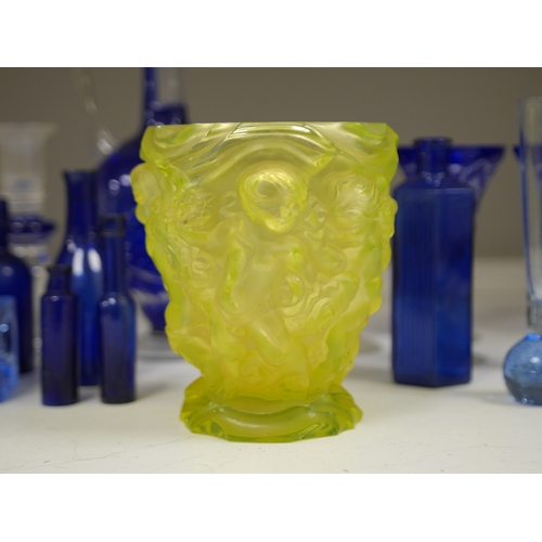 1372 - A yellow glass putti decorated vase, a blue glass decanter and other blue glassware, vase 18cm high.... 