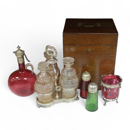 1399 - A cased silver plated three bottle liqueur stand, a cranberry decanter, sugar shaker and jam stand t... 