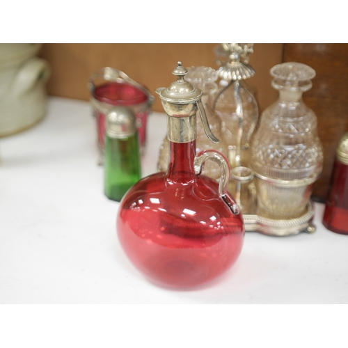 1399 - A cased silver plated three bottle liqueur stand, a cranberry decanter, sugar shaker and jam stand t... 