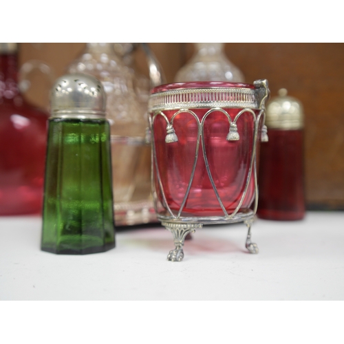 1399 - A cased silver plated three bottle liqueur stand, a cranberry decanter, sugar shaker and jam stand t... 