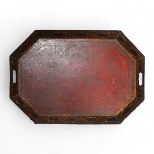 1412 - An early 19th century octagonal red painted toleware tray, possibly Pontypool, 66cm wide. Condition ... 