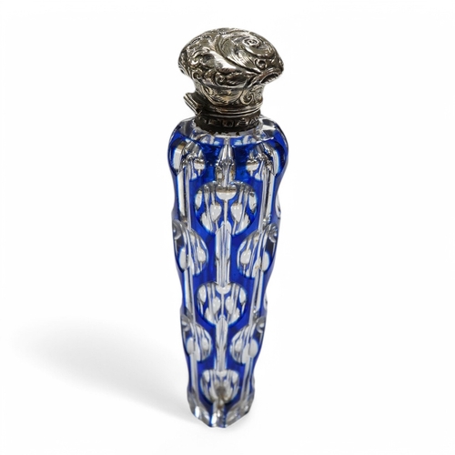 1436 - A 19th century silver topped blue overlay glass scent bottle, 11cm long. Condition - fine chips to b... 