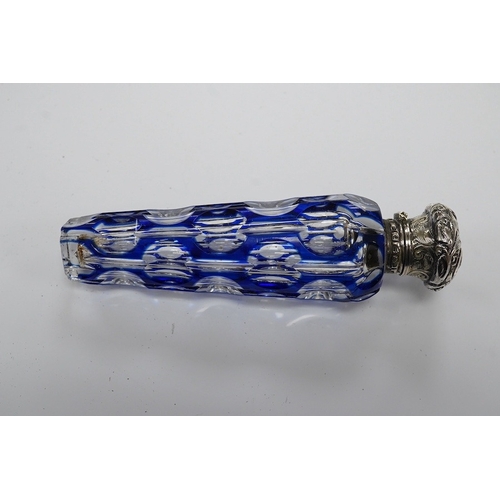 1436 - A 19th century silver topped blue overlay glass scent bottle, 11cm long. Condition - fine chips to b... 