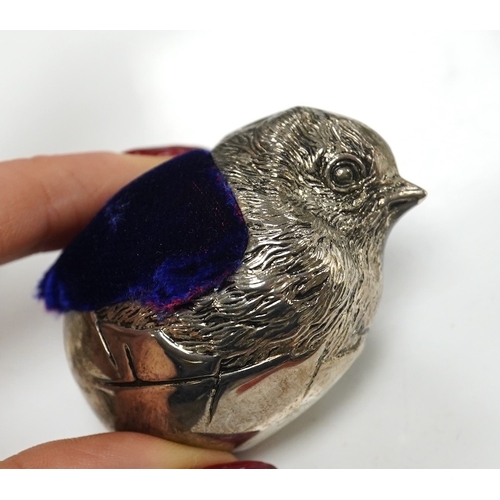 1839 - An unmarked white metal hatching chick pin cushion, height 44mm, an early Victorian coral and silver... 