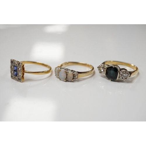 1913 - A 10k and three stone opal ring, with diamond set shoulders, an 18ct, sapphire and diamond three sto... 