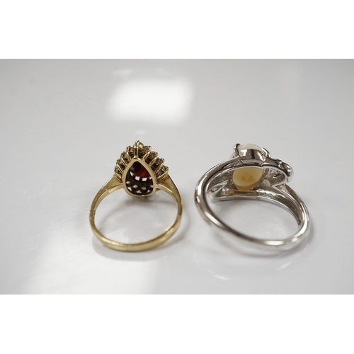 1920 - A modern 9ct white gold and single stone cabochon white opal set ring, size N and a 9ct gold, garnet... 