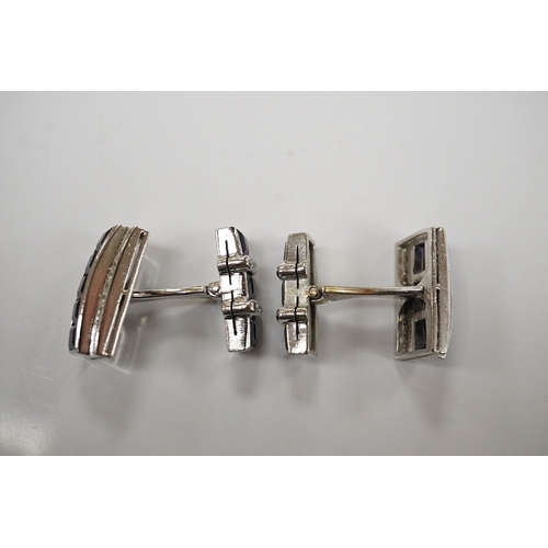 1922 - A pair of white metal, synthetic sapphire and diamond three row line cuff links, of curved rectangul... 