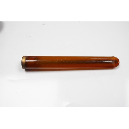 1927 - Three assorted cased cigarette holders, including amber, largest 10.1cm. Condition - fair