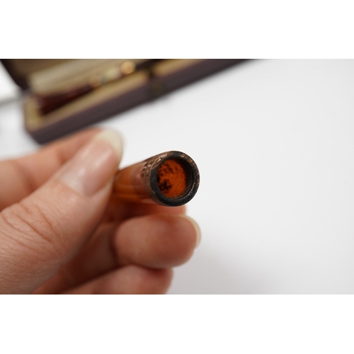 1927 - Three assorted cased cigarette holders, including amber, largest 10.1cm. Condition - fair