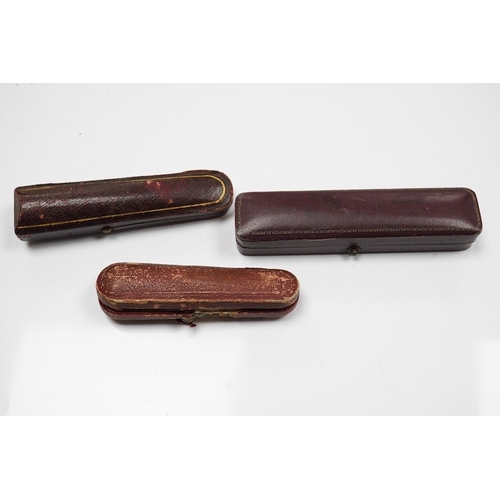 1927 - Three assorted cased cigarette holders, including amber, largest 10.1cm. Condition - fair