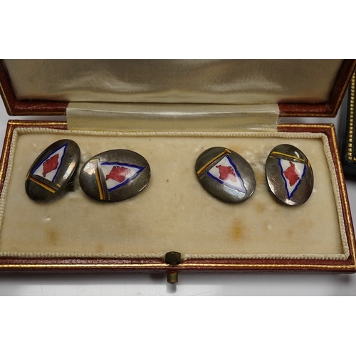 1930 - A cased pair of mid 20th century white metal and polychrome enamel oval cufflinks, by Benzies of Cow... 