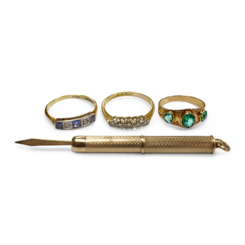 1935 - A group of three rings and a gold toothpick comprising: a five-stone French-cut synthetic sapphire a... 