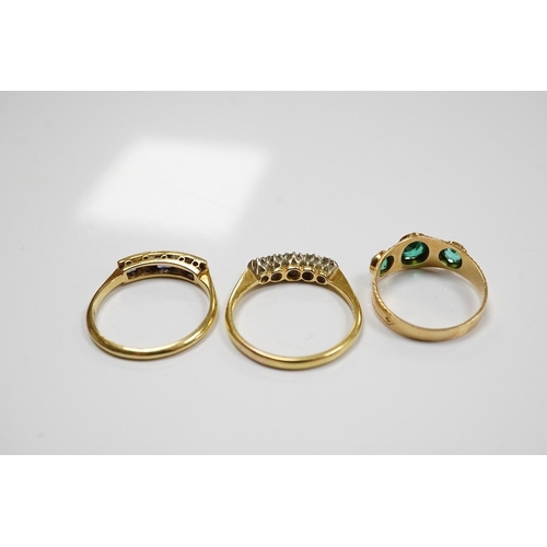 1935 - A group of three rings and a gold toothpick comprising: a five-stone French-cut synthetic sapphire a... 