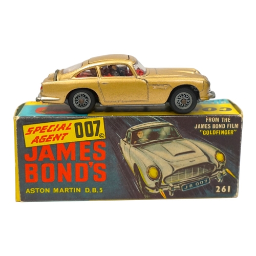 316 - A Corgi Toys (261) James Bond 007 Aston Martin in gold, together with its original box, card display... 