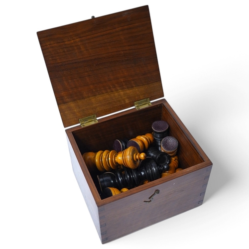 319 - A turned wooden chess set in ebony and boxwood, king 10.5cm high, in a hardwood box. Condition - goo... 