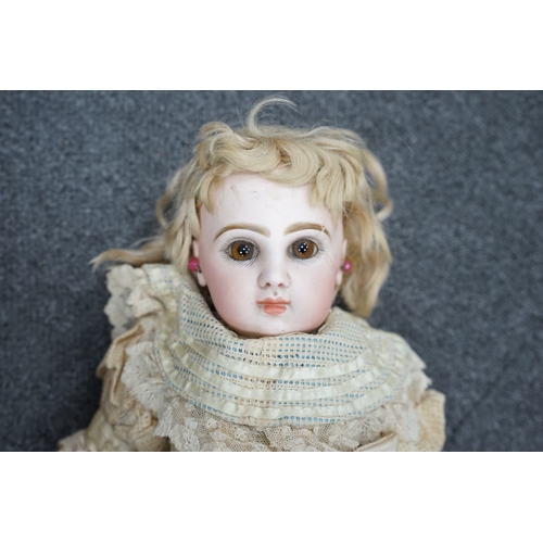 327 - A Tête Jumeau bisque doll, closed mouth and paperweight eyes, jointed wood and composition body, two... 