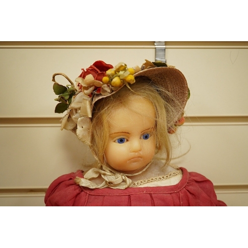 329 - A 19th century poured wax shoulder doll, paperweight eyes and jointed limbs, 60cm.  Condition - some... 